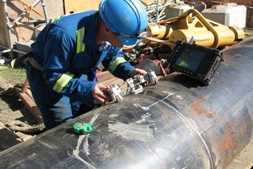 AMPS - NDT technician performing non-destructive testing on industrial equipment